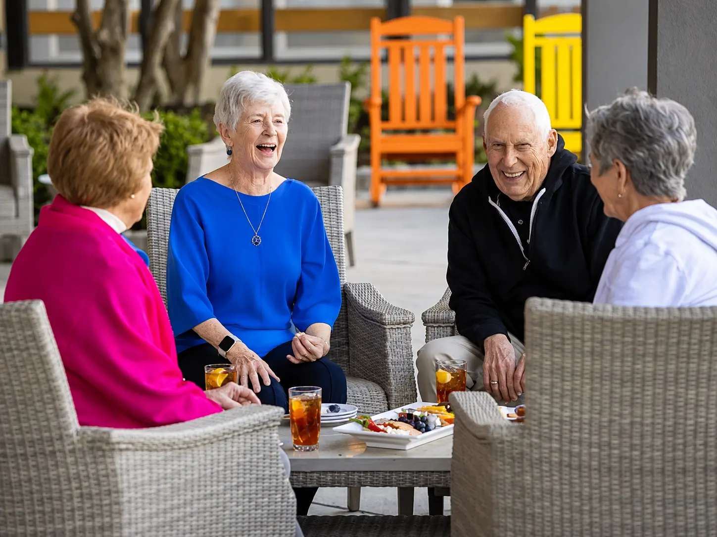 Residents laughing together on the patio at Legacy Assisted Living